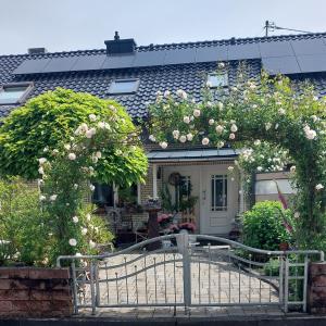 a house with an arch with roses on it at Landhaus Julia in Kobern-Gondorf