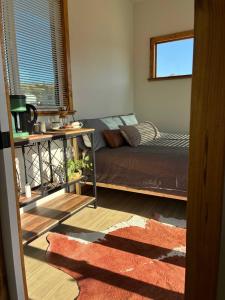 a bedroom with a bed and a window at Quiet Luxury Tiny Home Retreat Rustic Chic in Aguanga