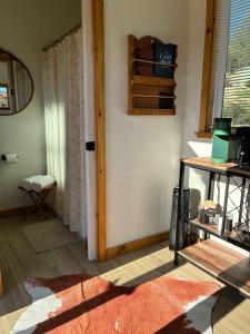 a room with a door and a table and a window at Quiet Luxury Tiny Home Retreat Rustic Chic in Aguanga +11 photos
