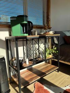 a table with a coffee maker on top of it at Quiet Luxury Tiny Home Retreat Rustic Chic in Aguanga