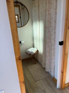a hallway with a mirror and a stool in a room at Quiet Luxury Tiny Home Retreat Rustic Chic in Aguanga