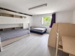 a bedroom with two bunk beds and a window at maison d'hôte et espace de repos in Prades