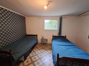 a bedroom with two beds and a window at maison d'hôte et espace de repos in Prades