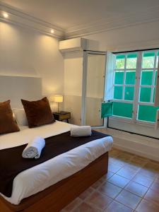 a bedroom with a large bed and a window at Oasis de César- Arquitectura Manriqueña in Costa Teguise