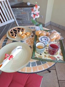 a table with plates of food and coffee on it at Vista Lago B&B in Gavirate +9 photos