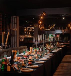 a long table with plates of food and wine glasses at Hotel Taurus in Solotvyno