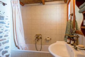 a bathroom with a tub and a sink and a shower at Elounda Collection Villa in Vrouchas +42 photos