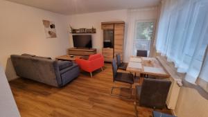 a living room with a couch and a table at Rudolph Apartments Kleve in Kleve