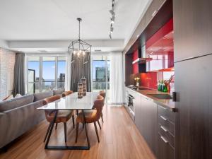 a kitchen and living room with a table and chairs at Avenue Suites - Toronto's Convention District in Toronto +29 photos
