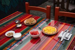 a colorful table with plates of food on it at Hostal Café Tiana in Latacunga