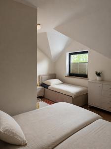 a bedroom with two beds and a window at Pod Skrzydłami II in Liksajny
