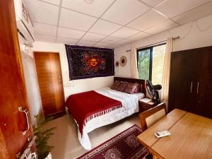 a small room with a bed and a table at The Nivasa Project in Agonda