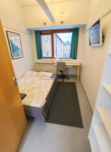 a small room with a bed and a desk at Office House Tripla in Helsinki +11 photos