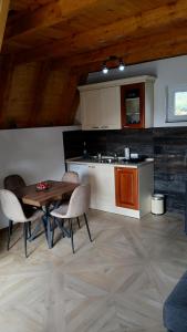 a kitchen with a table and chairs in a room at Durmitor Holiday in Žabljak