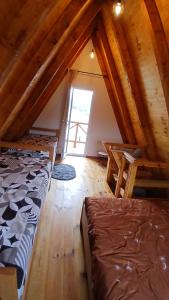 a attic room with two beds and a window at Durmitor Holiday in Žabljak