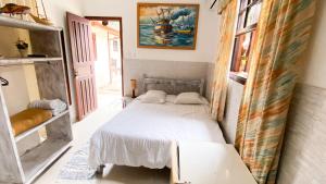 a bedroom with a white bed in a room at Pousada Mercador in Paraty +104 photos