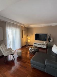 a living room with a couch and a flat screen tv at Apartment Francos in Primošten