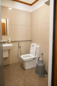 a bathroom with a toilet and a sink at Nova North Inn in Cochin