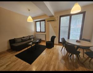 a living room with a couch and a table at Premium 1 One bedroom apartment Maksim Gorki street 8 in Skopje