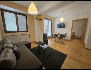 a living room with a couch and a table at Premium 1 One bedroom apartment Maksim Gorki street 8 in Skopje +10 photos