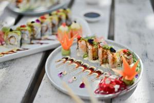 a row of plates of food on a table at Paradise Cove Marina in Jeffreys Bay