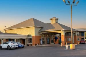 a building with cars parked in a parking lot at Aloha Inn McAllen Airport near Medical center Tx in McAllen