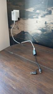a cord plugged into an electrical outlet on a wooden floor at La Couleur des Temps in Couiza