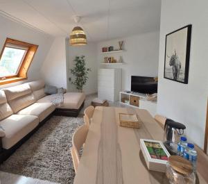 a living room with a couch and a table at Mar de Laxe Vistas al mar y Costa da Morte in Cabana de Bergantiños +8 photos