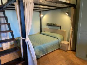 a small bedroom with a bed and a ladder at Loft Open Space, Capoliveri Centralissimo in Capoliveri +39 photos