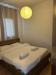 a bedroom with a bed with two towels on it at Protopapas House in Kato Amiandos