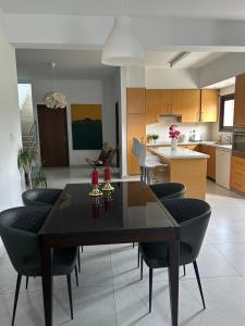 a dining room and kitchen with a table and chairs at Protopapas House in Kato Amiandos