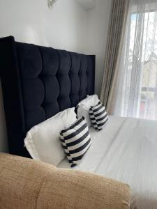 two pillows sitting on a bed with a window at Naivasha road Studio Opposite ILRI in Nairobi +6 photos