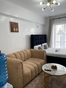 a living room with a couch and a bed at Naivasha road Studio Opposite ILRI in Nairobi