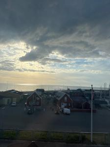a group of houses in a parking lot near the water at carlsens hotel in Vesterø Havn