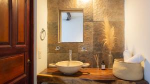 a bathroom with a bowl sink and a mirror at Punta Dreams in Brisas de Zicatela +31 photos