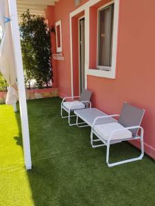 a group of chairs sitting on the side of a building at Moon studios in Lygia