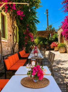 a long table with pink flowers on it at Just Datça in Datca