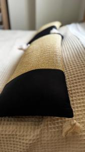 a black tie sitting on top of a bed at Villa Katerinaki in Kos