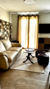 a living room with a couch and a table at Villa Katerinaki in Kos