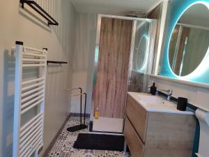 a bathroom with a sink and a shower with a mirror at Maisonnette de vignes avec vue imprenable in Marvejols +47 photos