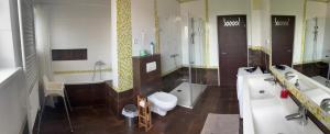 a bathroom with a toilet and a tub and a sink at Apartment Maximilian in Bratislava +48 photos