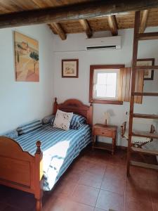a bedroom with a bed and a ladder in it at Monte dos Pintos in Arronches +28 photos