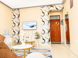 a living room with a door and a table at Joyland B&B in Mbita