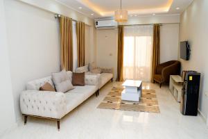 a living room with two couches and a tv at Djorff Palace - Private villa & swimming pool & central location in Al Aqālitah +29 photos