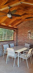 a patio with a table and chairs and a brick wall at CaSa ViTo Kumrovec in Brezje +26 photos