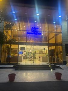 a building with a large window with a blue light at رولانا للشقق المخدومة Rolana Serviced Apartments in Jeddah