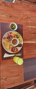 a table with a plate of food on a table at Tiptree Lodge in Livingstone