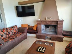 a living room with a couch and a fireplace at The View in Souvala