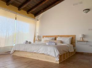 a bedroom with a large bed with two teddy bears on it at Il Giardino del Belvedere in Barrafranca