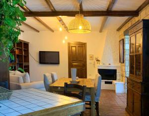 a living room with a table and a couch at Il Giardino del Belvedere in Barrafranca